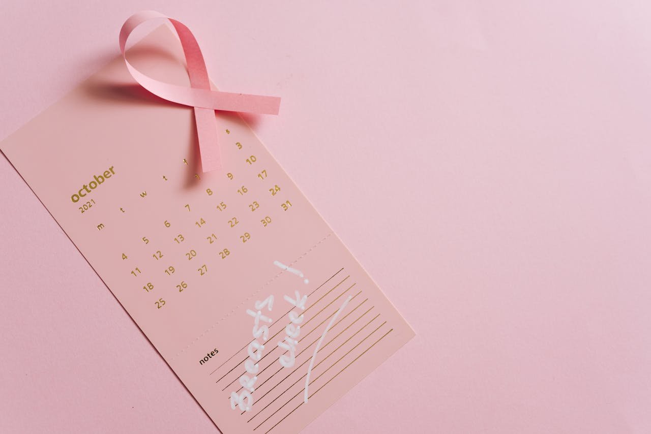 Pink October calendar with ribbon symbolizing breast cancer awareness, emphasizing early detection.